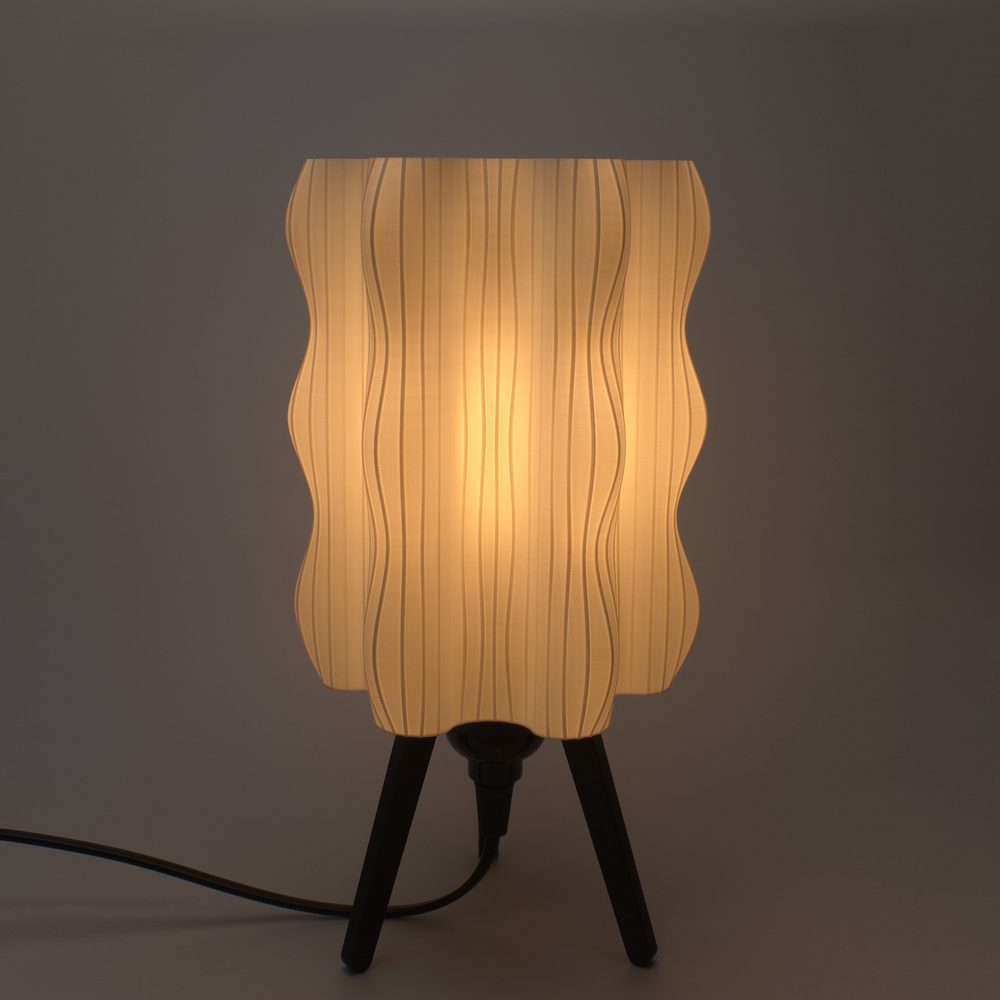 The Ripple Lamp in White, glowing